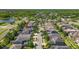 Wonderful aerial view of a home in a well-kept neighborhood with sidewalks, lush trees, ponds and landscaping at 9275 Bella Vita Cir, Land O Lakes, FL 34637