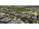 Lovely aerial view of a home in a charming neighborhood featuring beautiful landscaping, ponds and lush green trees at 9275 Bella Vita Cir, Land O Lakes, FL 34637