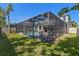Well-manicured backyard with a screened in pool and a white fence at 9275 Bella Vita Cir, Land O Lakes, FL 34637