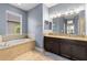 Bathroom boasts double sinks, granite countertops, a soaking tub, and ample cabinet space at 9275 Bella Vita Cir, Land O Lakes, FL 34637