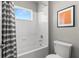 Bright bathroom with a shower-tub combo and a window at 9275 Bella Vita Cir, Land O Lakes, FL 34637