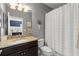 Bathroom featuring vanity with granite counters, dark wood cabinets, and shower with tub at 9275 Bella Vita Cir, Land O Lakes, FL 34637