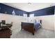 Comfortable bedroom with stylish blue accent wall and a dedicated workspace at 9275 Bella Vita Cir, Land O Lakes, FL 34637