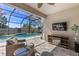 Relaxing screened patio with comfortable seating and view of the pool at 9275 Bella Vita Cir, Land O Lakes, FL 34637