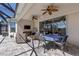 Spacious covered patio with ceiling fans, TV, and outdoor dining and living areas at 9275 Bella Vita Cir, Land O Lakes, FL 34637