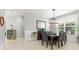 Dining area featuring a modern light fixture, neutral walls, and a window providing natural light at 9275 Bella Vita Cir, Land O Lakes, FL 34637