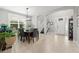 Open dining area with views of the entryway, staircase, and a bright window at 9275 Bella Vita Cir, Land O Lakes, FL 34637
