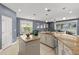 Open concept kitchen featuring granite countertops and stainless steel appliances open to the living room at 9275 Bella Vita Cir, Land O Lakes, FL 34637