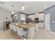 Kitchen featuring a granite countertop island with barstool seating and stainless steel appliances at 9275 Bella Vita Cir, Land O Lakes, FL 34637