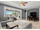 Open-concept living room showcasing sliding glass doors leading to the pool and outdoor seating area at 9275 Bella Vita Cir, Land O Lakes, FL 34637