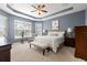 The main bedroom is spacious and features a tray ceiling and lots of natural light at 9275 Bella Vita Cir, Land O Lakes, FL 34637