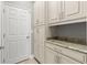 Spacious mudroom with abundant storage, custom cabinets and granite countertops at 9275 Bella Vita Cir, Land O Lakes, FL 34637