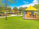 Community playground with swings, slides, picnic tables and shelters provides a fun, safe outdoor recreation area for residents at 9275 Bella Vita Cir, Land O Lakes, FL 34637