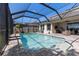 Covered patio area overlooking the screened pool, complete with outdoor furniture and a ceiling fan at 9275 Bella Vita Cir, Land O Lakes, FL 34637