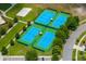 Amazing aerial view of tennis courts, a basketball court, and a sand volleyball court in a well-kept neighborhood at 9275 Bella Vita Cir, Land O Lakes, FL 34637