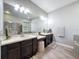 The bathroom has a vanity with granite top and a decorative stool at 9808 Milano Dr, Trinity, FL 34655