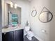 Cozy bathroom features a granite vanity top, framed mirrors, and stylish vanity lighting at 9808 Milano Dr, Trinity, FL 34655
