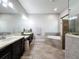 Elegant primary bathroom featuring dual vanities, soaking tub, and glass enclosed shower at 9808 Milano Dr, Trinity, FL 34655