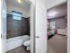 Clean bathroom with a tiled tub and shower, viewed through a doorway from the bedroom at 9808 Milano Dr, Trinity, FL 34655