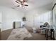 Neutral bedroom with large rug, ceiling fan, and rocking chair near two closets at 9808 Milano Dr, Trinity, FL 34655