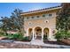 Clubhouse exterior with arched entrance, red tile roof, and lush landscaping at 9808 Milano Dr, Trinity, FL 34655
