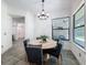 Dining room with stylish chandelier, large window, and views into an open living area at 9808 Milano Dr, Trinity, FL 34655