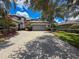 Charming home featuring a large driveway and a well-maintained two-car garage with lush landscaping at 9808 Milano Dr, Trinity, FL 34655