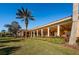 Beautiful exterior view of the home with a covered patio, lush landscaping and palm trees at 9808 Milano Dr, Trinity, FL 34655