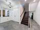 Welcoming foyer featuring a staircase and views into the main living areas at 9808 Milano Dr, Trinity, FL 34655