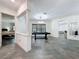 Bright and airy game room with a chandelier, tile floor and pool table for entertainment at 9808 Milano Dr, Trinity, FL 34655