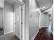 The hallway has wood floors and neutral paint at 9808 Milano Dr, Trinity, FL 34655