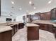 Spacious kitchen with dark wood cabinets, tile flooring, granite countertops, and center island at 9808 Milano Dr, Trinity, FL 34655