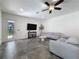 Bright living room featuring a ceiling fan, neutral paint, modern furnishings, and outside access at 9808 Milano Dr, Trinity, FL 34655