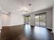 Bright living room with dark wood floors, access to a balcony, and a modern ceiling fan at 9808 Milano Dr, Trinity, FL 34655