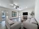 Comfortable living area with neutral paint, ceiling fan, and access to the patio and backyard at 9808 Milano Dr, Trinity, FL 34655