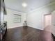 Spacious living room with dark wood floors, a window with blinds, and modern lighting fixture at 9808 Milano Dr, Trinity, FL 34655