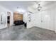 Spacious living room featuring tile flooring, crown molding, and wood accent wall with a leather sofa at 9808 Milano Dr, Trinity, FL 34655