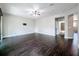 Large living room featuring dark wood floors, balcony access, and a view into an adjacent room at 9808 Milano Dr, Trinity, FL 34655