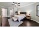 Well-lit primary bedroom with neutral colors, a fan, dark floors, and modern furniture at 9808 Milano Dr, Trinity, FL 34655