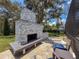 Enjoy the outdoors with this stone fireplace and bench with seating at 9808 Milano Dr, Trinity, FL 34655