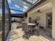 This outdoor kitchen features built-in appliances, a grill, and an overhang for shade at 9808 Milano Dr, Trinity, FL 34655