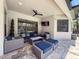 Covered outdoor patio featuring comfortable seating, a ceiling fan, and tiled flooring at 9808 Milano Dr, Trinity, FL 34655