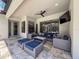 Covered outdoor patio featuring comfortable seating, a ceiling fan, and tiled flooring at 9808 Milano Dr, Trinity, FL 34655