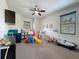 Bright playroom features a ceiling fan, natural light, and an array of toys and activities at 9808 Milano Dr, Trinity, FL 34655
