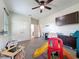 Open playroom with toys, storage, and seating under a ceiling fan, offering a fun space for  at 9808 Milano Dr, Trinity, FL 34655