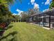 Enjoy Florida weather with the screen-enclosed pool and large backyard at 9808 Milano Dr, Trinity, FL 34655