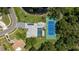 Aerial view of the property featuring a tennis court, a pool and solar panels on the roof at 13710 Westshire Dr, Tampa, FL 33618
