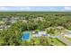 Expansive property featuring a pool, tennis court, lush landscaping and a tranquil pond at 13710 Westshire Dr, Tampa, FL 33618