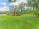 Expansive backyard features lush lawn, pond, and mature trees at 13710 Westshire Dr, Tampa, FL 33618