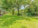 Lush green backyard shaded by mature trees, offering a serene and private outdoor space at 13710 Westshire Dr, Tampa, FL 33618